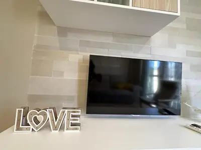 a large flat screen tv on a wall at Apartamentos Chiclana Chalet Carboneros in Chiclana de la Frontera