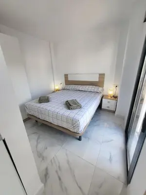 a bedroom with a bed with a marble floor at Apartamento Gloria Bendita in Jerez de la Frontera