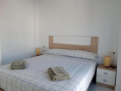 a bedroom with a bed with towels on it at Apartamento Gloria Bendita in Jerez de la Frontera