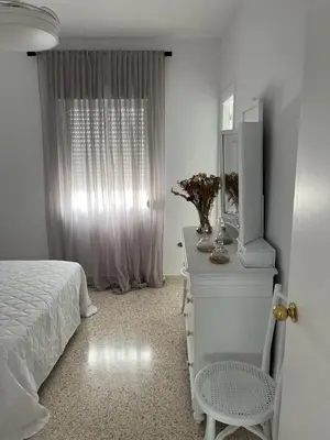a bedroom with a bed and a dresser with a mirror at Casa Gran Cinema in Sanlúcar de Barrameda