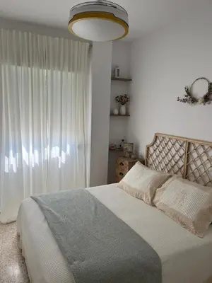 a bedroom with a bed and a large window at Casa Gran Cinema in Sanlúcar de Barrameda