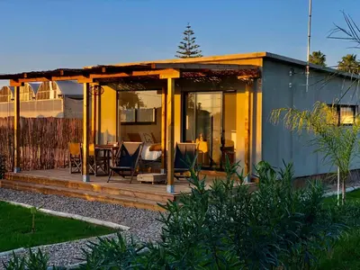 a small house with a porch and a patio at Casa Isabelina Stay near Doñana & the Coast in Sanlúcar de Barrameda