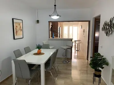 a dining room with a white table and chairs at Apartamento HS Costa Castillo in Poblado de Sancti Petri