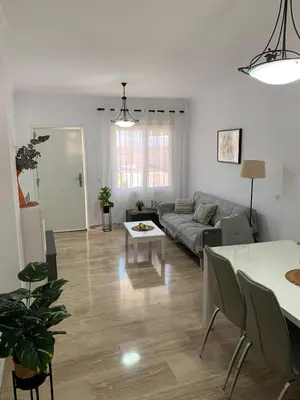 a living room with a couch and a table at Apartamento HS Costa Castillo in Poblado de Sancti Petri