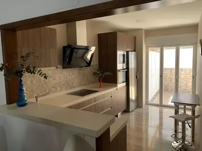 a kitchen with a refrigerator and a counter top at Apartamento HS Costa Castillo in Poblado de Sancti Petri