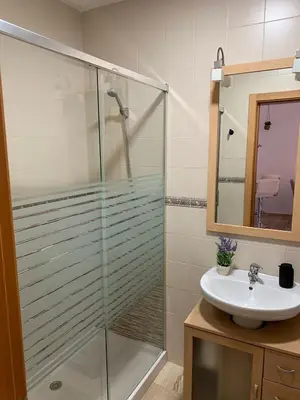 a bathroom with a glass shower and a sink at Apartamento HS Costa Castillo in Poblado de Sancti Petri