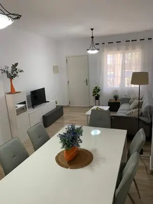 a living room with a white table and a couch at Apartamento HS Costa Castillo in Poblado de Sancti Petri