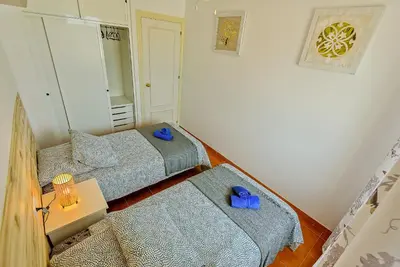 a small room with two beds and a mirror at Beachfront Duplex 1ª línea & Terraces Oceanfront in El Puerto de Santa María