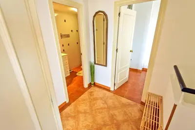a hallway with a mirror on the wall and a bathroom at Beachfront Duplex 1ª línea & Terraces Oceanfront in El Puerto de Santa María
