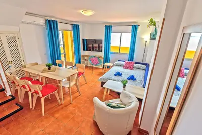 a living room with a table and a couch at Beachfront Duplex 1ª línea & Terraces Oceanfront in El Puerto de Santa María