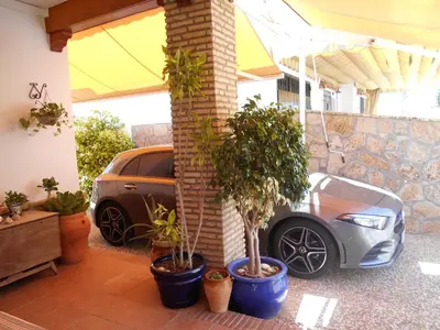 a car parked in a garage with potted plants at Apartamento Caracola in Chipiona