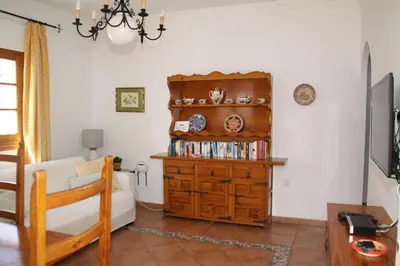 a bedroom with a bed and a book shelf at Apartamento Caracola in Chipiona