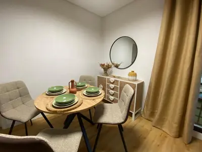 a dining room with a table and chairs and a mirror at El Paraíso de Fuentebravía - Primera Línea de Playa in El Puerto de Santa María