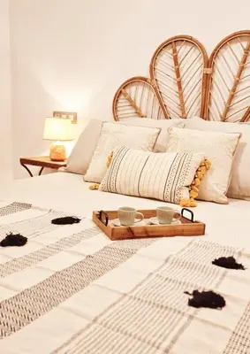 a bed with two cats on it with a tray on it at El Paraíso de Fuentebravía - Primera Línea de Playa in El Puerto de Santa María