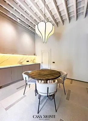 a dining room with a table and chairs at Casa Monti - Sherry Suites A in Jerez de la Frontera