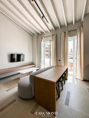 a living room with a table and a couch at Casa Monti - Sherry Suites A in Jerez de la Frontera