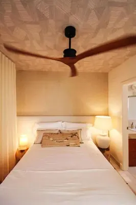 a bedroom with a bed with a ceiling fan at Casa de lujo en Las Redes in El Puerto de Santa María
