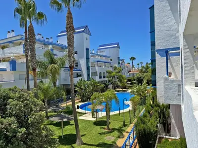 an aerial view of a resort with a swimming pool and palm trees at Apartamento Playa Ballena - Ole Solutions in Costa Ballena