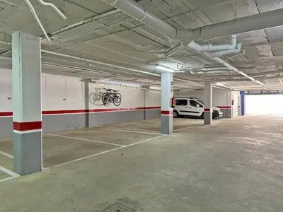 an empty parking garage with a bike on the wall at Apartamento Playa Ballena - Ole Solutions in Costa Ballena