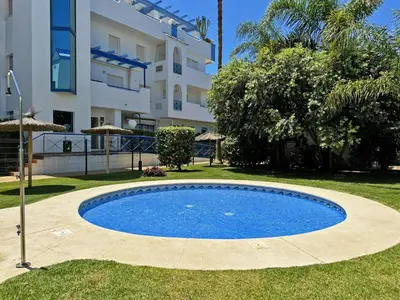 a swimming pool in front of a building at Apartamento Playa Ballena - Ole Solutions in Costa Ballena