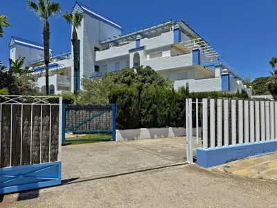 a blue and white gate in front of a building at Apartamento Playa Ballena - Ole Solutions in Costa Ballena