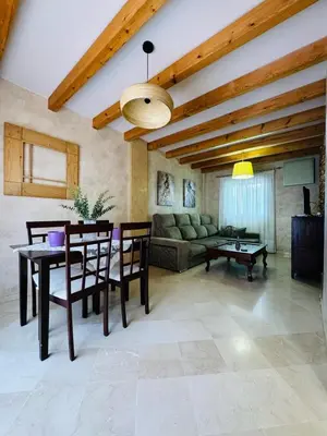 a living room with a table and a couch at Casa Familiar- Residencial Solmar in Sanlúcar de Barrameda