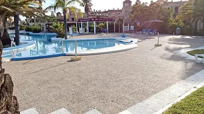 a pool with a slide in a resort at Apartamentos Jasmund - Bungalow 117 in San Fernando