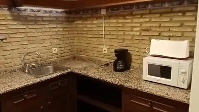 a kitchen with a sink and a microwave on a counter at Apartamentos Jasmund - Bungalow 117 in San Fernando