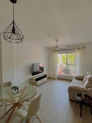 a living room with a glass table and a couch at Apartamento en Costa Ballena in Chipiona