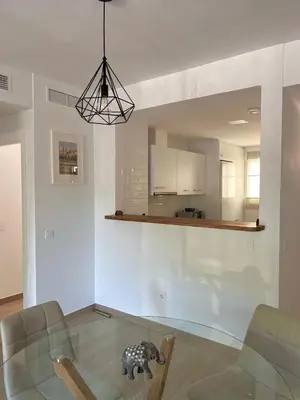 a living room with a glass table with a toy dog on it at Apartamento en Costa Ballena in Chipiona