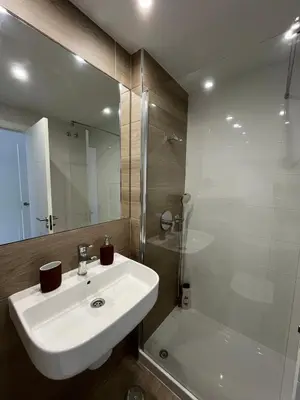 a bathroom with a sink and a shower and a tub at Apartamento en Costa Ballena in Chipiona