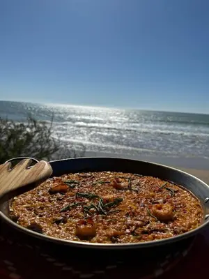 a pan of food in front of the beach at Apartamento en Costa Ballena in Chipiona
