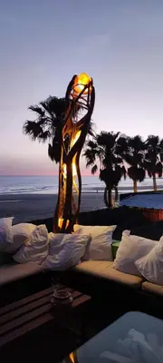a group of beds with a lamp on a beach at Apartamento en Costa Ballena in Chipiona