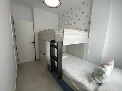 a small room with a bunk bed in it at Playa La Barrosa, AlojamientosLola in Chiclana de la Frontera