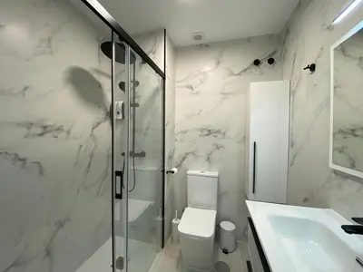 a bathroom with a shower and a toilet and a sink at Playa La Barrosa, AlojamientosLola in Chiclana de la Frontera