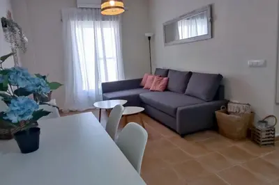 a living room with a couch and a table at Precioso apartamento en Rota in Rota