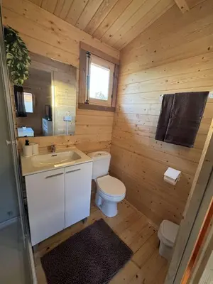 a small bathroom with a toilet and a sink at Bungalow Luna in Chiclana de la Frontera