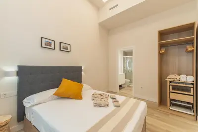 a bedroom with a bed with two shoes on it at Urania Cadiz Apartments by Soho Boutique in Cádiz