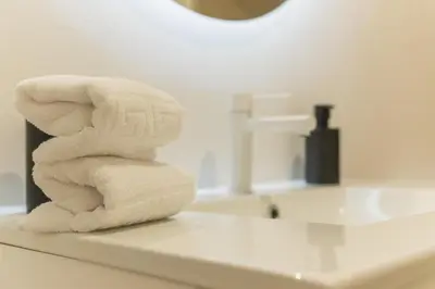 a stack of towels sitting on top of a bathroom counter at Urania Cadiz Apartments by Soho Boutique in Cádiz