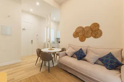 a living room with a couch and a table at Urania Cadiz Apartments by Soho Boutique in Cádiz