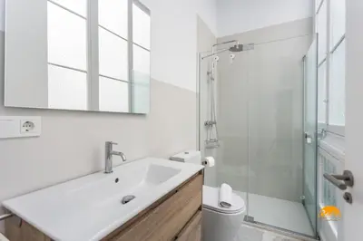 a white bathroom with a sink and a shower at Casa Amanecer by Cádiz Time in Cádiz
