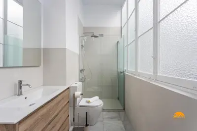 a bathroom with a toilet and a sink and a shower at Casa Amanecer by Cádiz Time in Cádiz