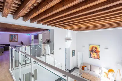 a staircase in a house with wooden ceilings at Casa Amanecer by Cádiz Time in Cádiz