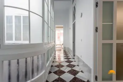 a hallway with a black and white checkered floor at Casa Amanecer by Cádiz Time in Cádiz