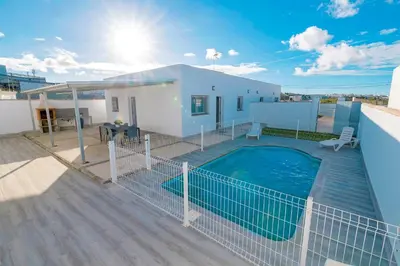 a swimming pool on the roof of a house at Poniente in Chiclana de la Frontera