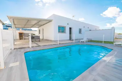 a bedroom with two bunk beds and a mirror at Poniente in Chiclana de la Frontera