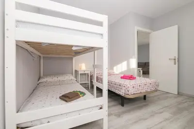 a kitchen with white cabinets and a white refrigerator at Poniente in Chiclana de la Frontera