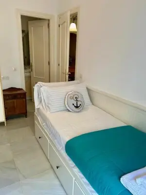 a white bed with a pillow on top of it at GATU el Capitán 