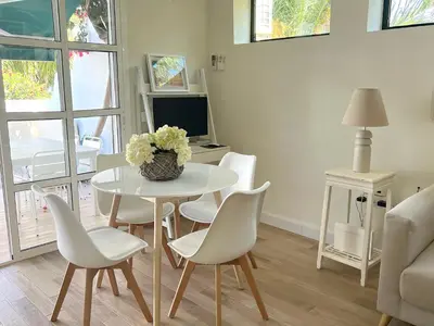 a living room with a white table and chairs at La Buganvilla in Chiclana de la Frontera