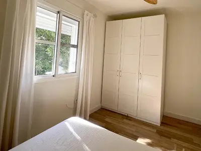 a bedroom with a bed and a window at La Buganvilla in Chiclana de la Frontera